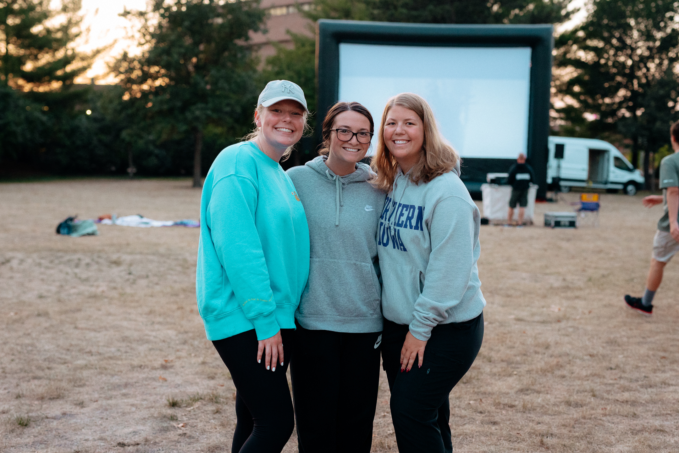 Students standing near an outdoor movie screen
