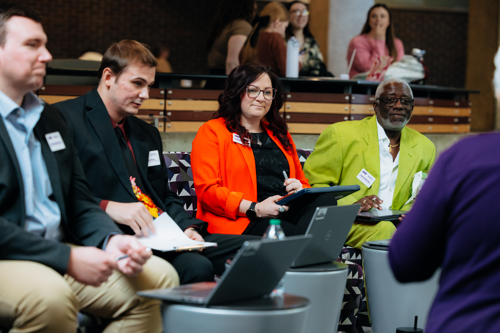 Four office professionals sitting on a stage