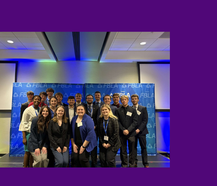 Group of students in front of a blue backdrop 
