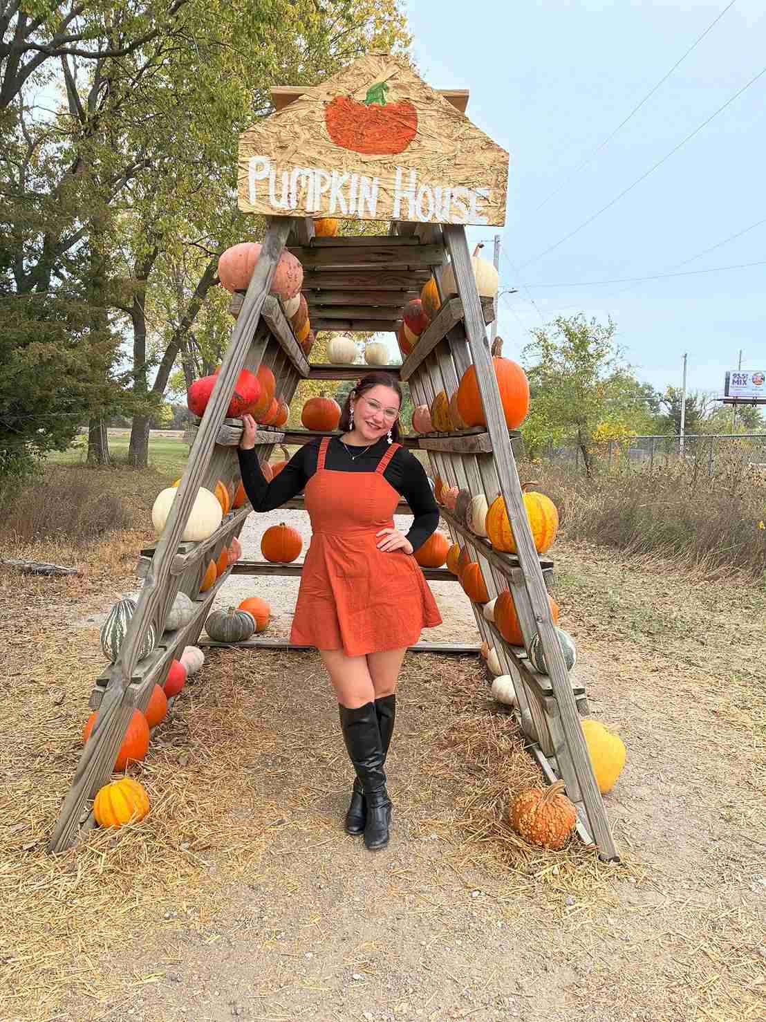 Girl standing outside a pumpkin patch