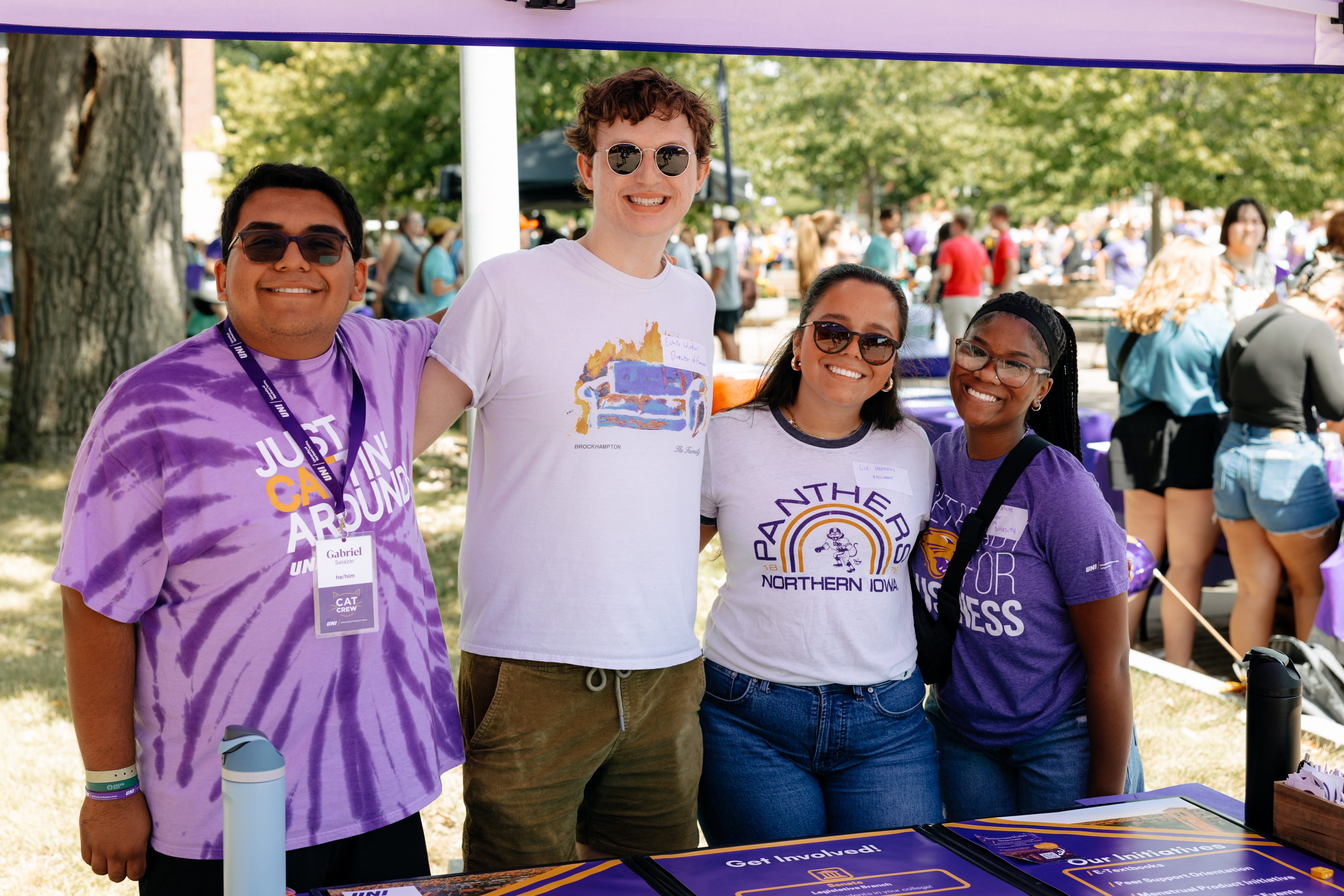 Four students standing outside smiling
