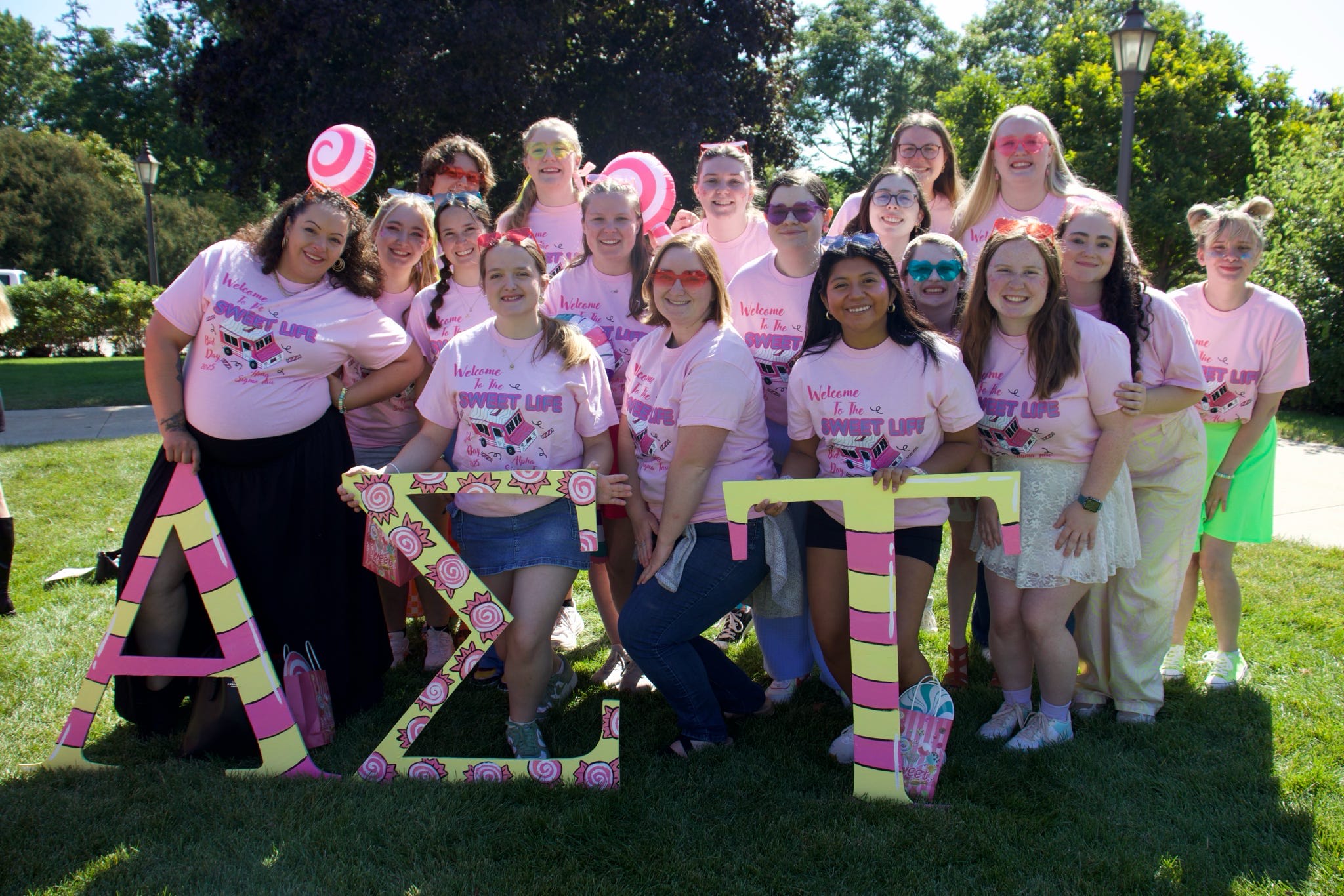 Sorority women behind AST letters