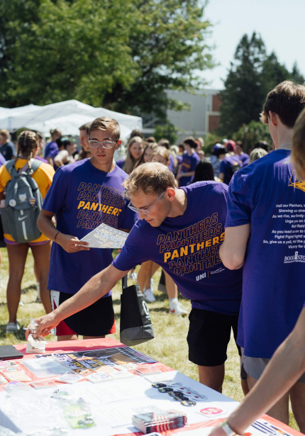 Students gathering outside around a table