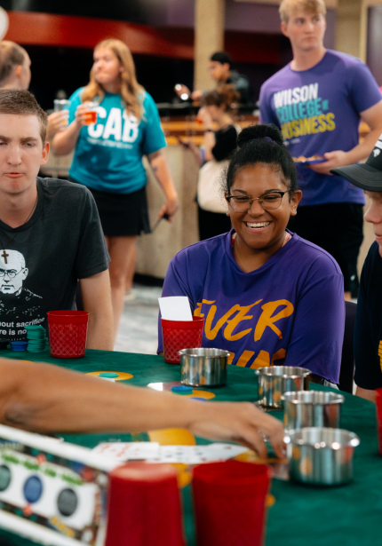 People around a poker table smiling