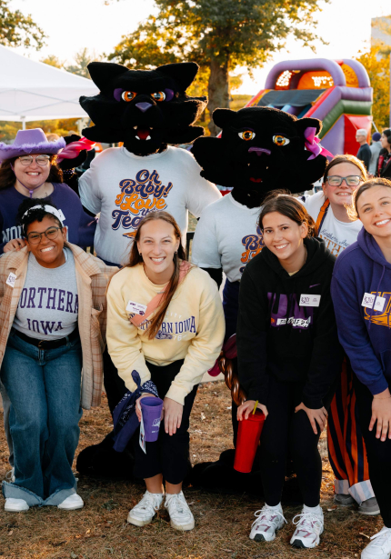 Group of students posing with two panther mascots