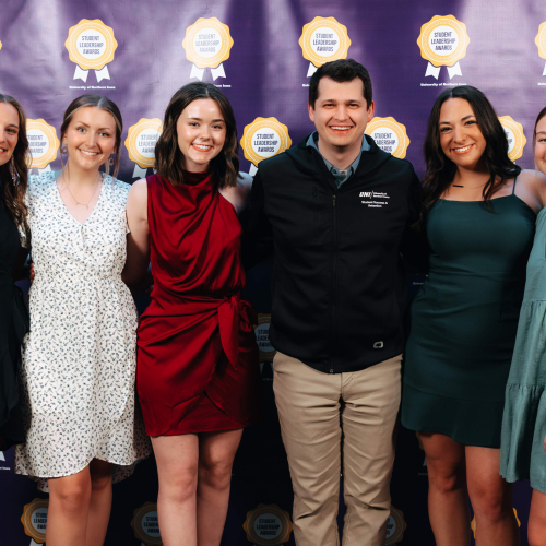 Five student organization members with their advisor