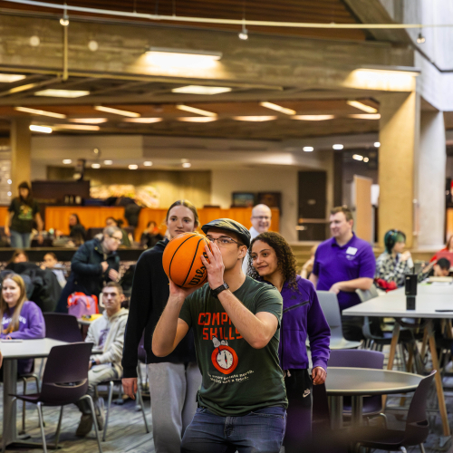 Man shooting a basketball in Maucker Union