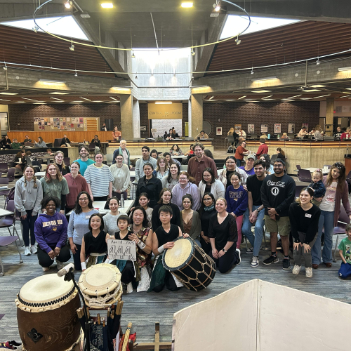 Group in Maucker Union posing with drummers
